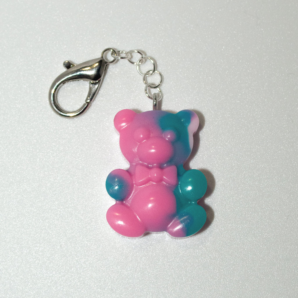 Pink and blue teddy bear keychain on a white background